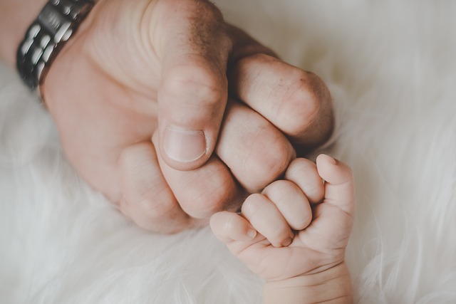 Father and infants' hands